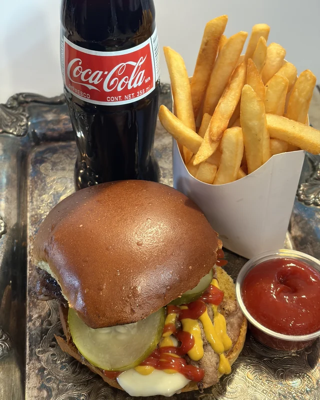 The Sum Pig lunch special: steak burger, fries and a Coca-Cola on a silver tray