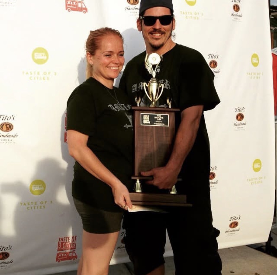 Jessica and Stephen of Sum Pig holding the Mayor's Cup trophy at Taste of 3 Cities