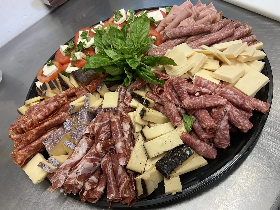 Sum Pig classic antipasto tray with cured meats, cheeses, caprese and fresh basil