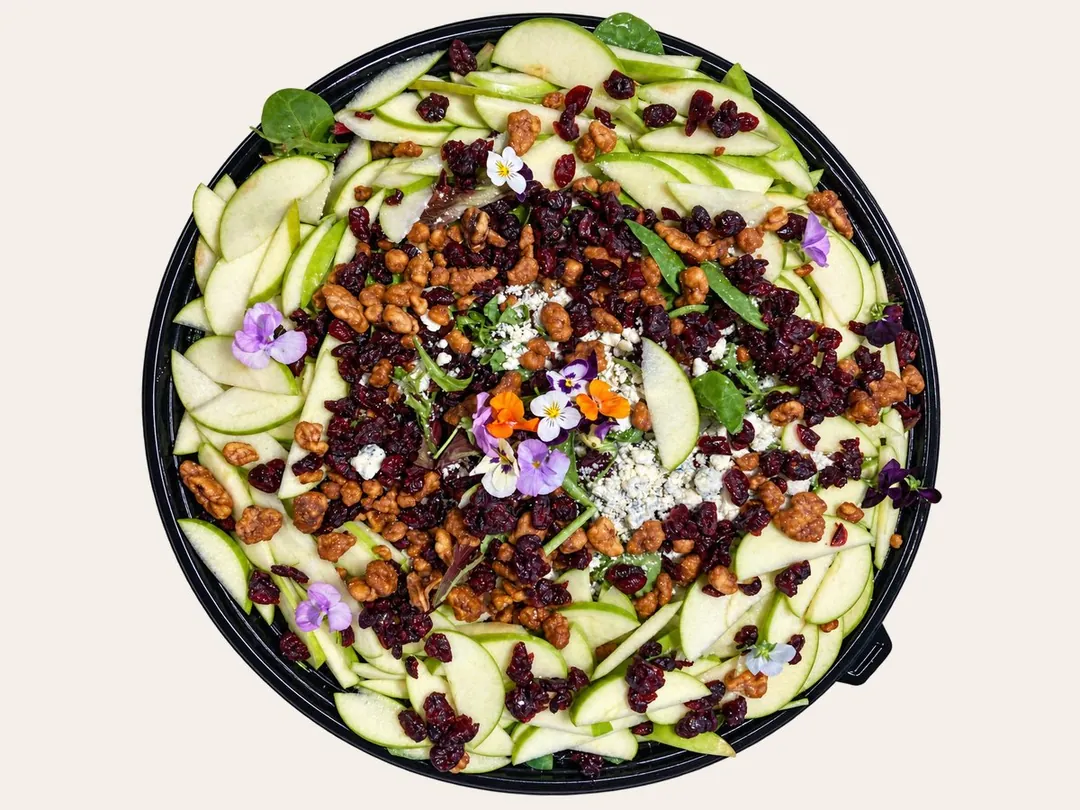 Sum Pig apple walnut Gorgonzola salad with Granny Smith apples, candied walnuts, dried cranberries and edible flowers